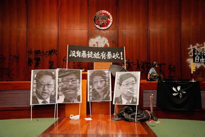 2019年7月1日,逾百示威者一度占领立法会。图为7月2日立法会议厅摆放标语牌“没有暴徒只有暴政!”,和被污损的肖像。(美联社)